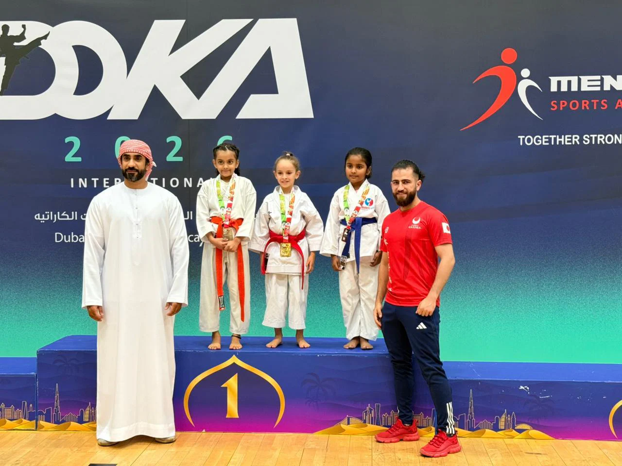 Three young medallists on the podium at DOKA 2026 International in Dubai