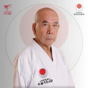 Sensei Oishi Takeshi, current JKA Chief Instructor, in white gi with JKA emblem