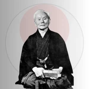 Sensei Gichin Funakoshi, founder of Shotokan karate-do, seated in traditional dress