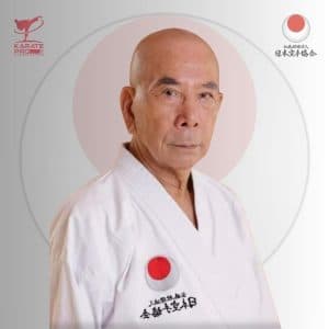 Sensei Oishi Takeshi, current JKA Chief Instructor, in white gi with JKA emblem