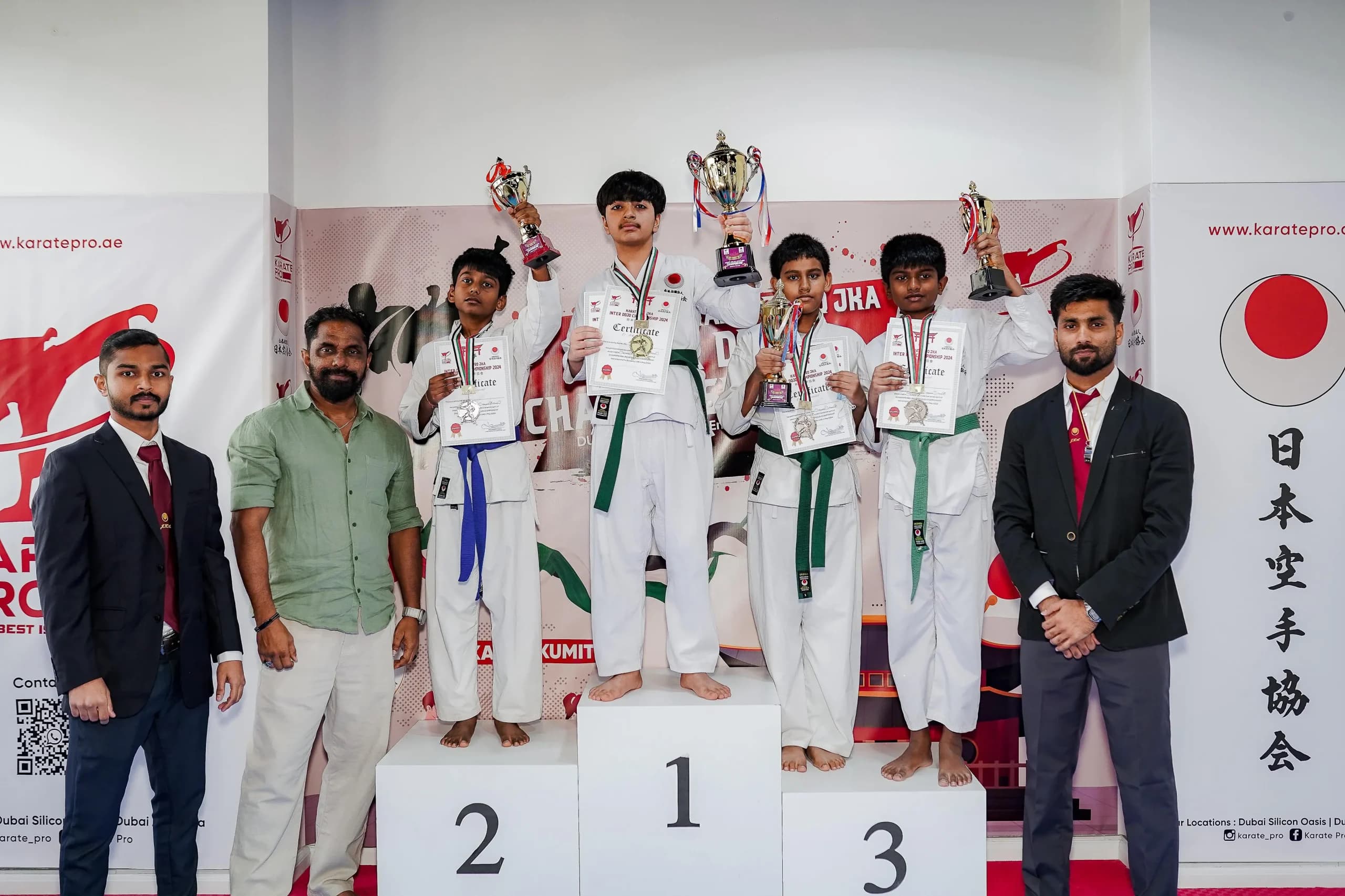 Summer camp students on the podium at a 2024 championship