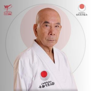Sensei Oishi Takeshi, current JKA Chief Instructor, in white gi with JKA emblem