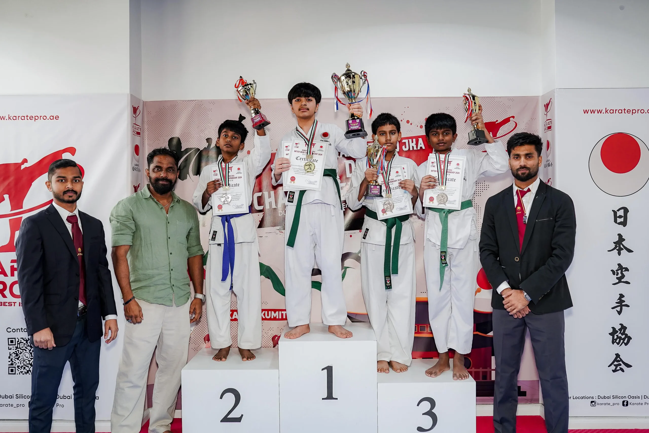 Summer camp students on the podium at a 2024 championship
